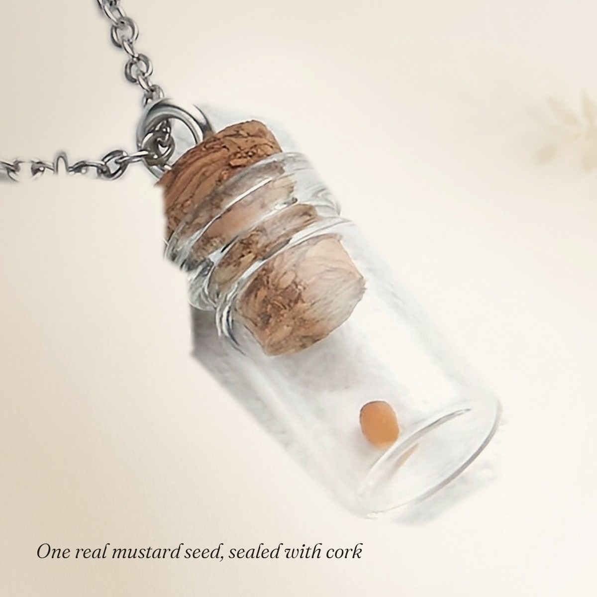 Close-up of the single real mustard seed inside the corked glass vial